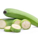 Sliced ​​green banana with peel.