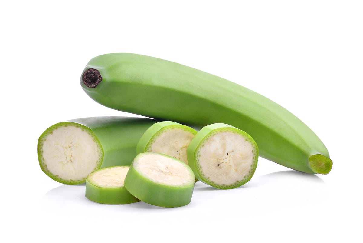 Sliced ​​green banana with peel.